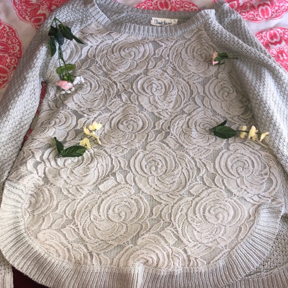 Gray sweater with decorative flowers on front